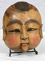 Front view of the Thai hand carved wooden mask showing facial details and paint.