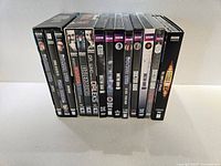 Side view of the 16 Doctor Who DVDs standing vertically showing spines and labels
