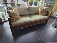 Front view of sofa with decorative pillows against window