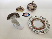 Six-piece ladies vanity collection arranged on a white surface showing combs, figurine, trinket box, and dish.