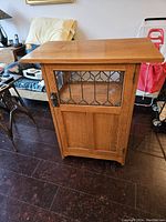 Front view of quarter-sawn oak mission style cabinet with single door and leaded glass panel