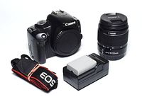 Kit laid out: camera body, lens, battery/charger, strap