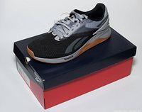 Side view of one Reebok Nano X3 shoe on top of original box showing overall style, color, and branding.