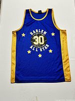 Full front view of the Harlem All Star basketball jersey showing blue center, yellow sides, and large printed design with number 30.