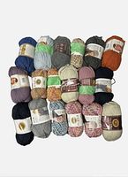 Eighteen skeins of yarn arranged in rows showing variety of colors and labels, mostly Lion Brand Thick and Visit Quick yarn.