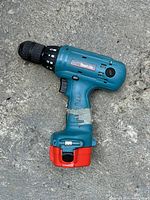 Side view of Makita cordless drill showing model number and wear.