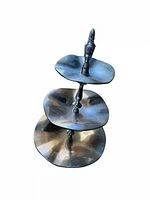 Overall view of the three-tier silver serving tray from an angle showing the tiered plates and central handle.