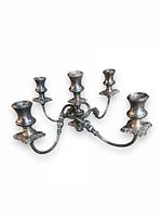 Front angled view of the vintage silver-plated 4-arm candelabra showing the candle holders and ornate arms.