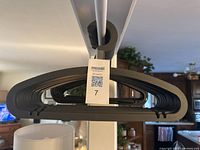 Close-up side view showing thickness of 17 thicker grey plastic Ikea clothes hangers stacked together