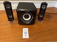 Photo showing two satellite speakers and one subwoofer from front