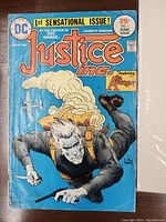 Front cover of Justice Inc. No. 1 comic book with character in action and price clearly visible