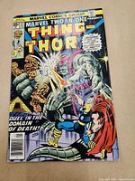 Front cover of Marvel Two-in-One No. 23 comic book showing Thing and Thor in action pose with comic title and issue information visible.