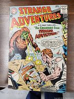 Full front cover of the 1964 Strange Adventures No. 170 comic showing the creature and a man on the cover.
