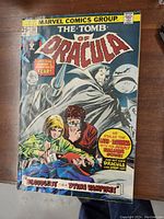 Photo of comic cover showing title, issue number 38, Marvel Comics Group branding, colorful characters including Dracula and others, priced at 25 cents. Condition shows wear mostly at edges and spine.