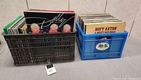 Crates containing a large number of vinyl records including visible Dolly Parton albums.
