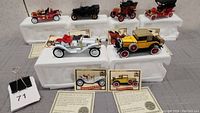 Full view of 6 Golden Age of Ford 1:32 scale cars and trucks models displayed on white foam holders with certificates