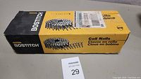 Box of Bostitch coil nails labeled Coil Nails Clavos en rollo Clous en bobine