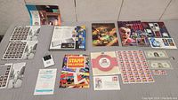 Overview of stamps and Elvis memorabilia laid out on a gray surface.