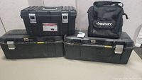 Lot overview showing two Stanley FatMax tool boxes, one black Stanley tool box, and one black Husky tool bag.