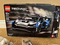 Damaged LEGO Technic set box for 42123 McLaren Senna GTR, 830 pieces, black and blue car model on box front