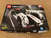 Front view of the LEGO Technic Porsche 99X Electric set 42137 box showing the assembled pull-back car model.