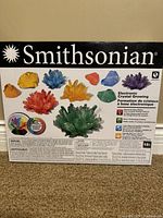 Front of Smithsonian Electronic Crystal Growing kit showing colorful crystal examples and product branding.