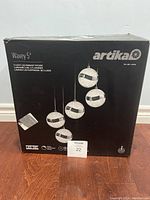 Box of Artika Wavey 5-light LED pendant fixture showing the product image and branding