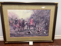 Framed fox hunting scene print with three riders and dogs in an outdoor setting.