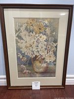 Full view of framed floral artwork showing the entire piece including frame and matting.