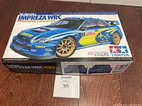 Box showing Tamiya Subaru Impreza WRC Monte Carlo 2005 rally car model kit.