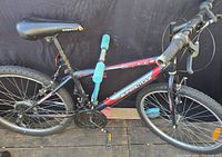 Side view of the Supercycle mountain bike showing frame, wheels, seat, and handlebar.