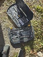 Top-down view of the open tool case showing all tools arranged in molded trays including ratchets, sockets, wrenches, hex keys and bits.