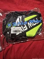 Photo of the PAW FIVE large dog harness in original sealed plastic packaging showing the lime green and black harness with visible branding.