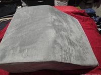 Front angle view showing the wedge shape and grey fabric cover on the memory foam pillow.