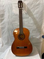 Front view of Westminster acoustic guitar, natural wood top, nylon strings, classical body