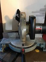 Full view of the Delta 10 inch power miter saw showing blade, base with degree markings, handle, and blade guard.