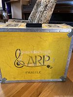 Yellow equipment road box with ARP logo and metal reinforced edges and latches, showing front view.