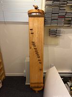 Front view of the Koto instrument showing one side with tuning pegs and bridges.
