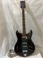 Front full view of guitar showing body shape, finish, and strap attachment