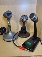 All three microphones side by side on shelf.