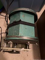 Photo of the Scott-Murray Rick rock tumbler showing the motor attachment and drum secured by wing nuts.