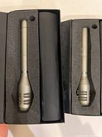 Two AT811 microphones seated in open foam-lined plastic cases, showing overall lot contents