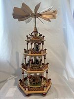 Full front view of entire carousel showing all four tiers and fan blades