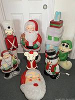 All seven blow molds arranged on floor against a door.