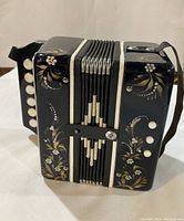 Mini accordion showing the floral pattern and white buttons