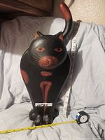 Front view of the hand carved wooden cat statue showing its size and painted details.