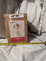 Photo of the figurine box with measuring tapes showing height approximately 8 inches