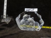 Side view showing the two baby polar bear crystal sculptures on base with measuring tape for size reference.