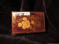 Top view closed showing floral wood inlay design on lid with sticker reading Lot 13
