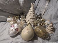 Group photo of three Lenox Christmas figurines; one large glowing tree and two smaller ivory china jewel embellished trees.